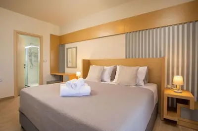 a bedroom with a large bed with towels on it at Melilia luxury villa in Gennadi