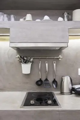 a kitchen with a sink and utensils on a shelf at Lindian Pearl in Líndos
