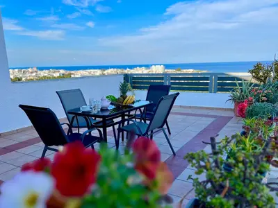 a table and chairs on a balcony with a view of the ocean at Ocean view Apartment in Rhodes Town