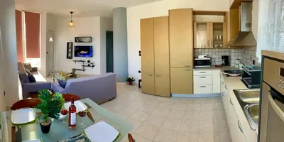 a kitchen and living room with a couch and a table at Ocean view Apartment in Rhodes Town