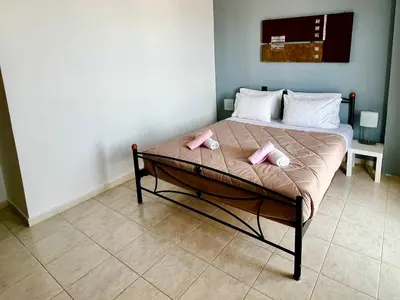 a bed with two pink pillows on it in a room at Ocean view Apartment in Rhodes Town
