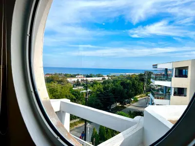 a view of the ocean from a window at Ocean view Apartment in Rhodes Town