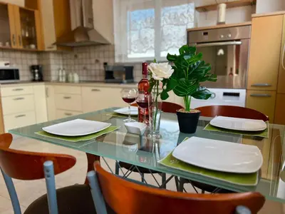 a kitchen with a table with plates and glasses of wine at Ocean view Apartment in Rhodes Town