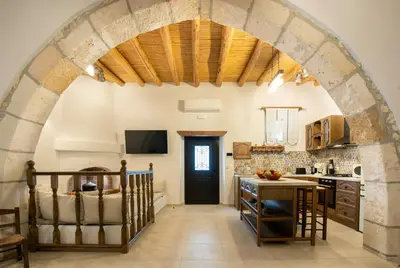 a kitchen with an archway in a house at Mareò Traditional Retreat in Archangelos