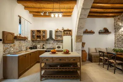 a kitchen with wooden ceilings and a table with fruits on it at Mareò Traditional Retreat in Archangelos