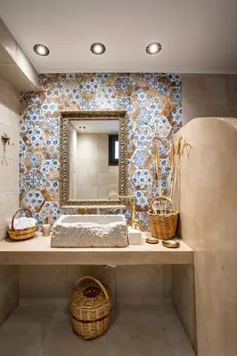a bathroom with a sink and a mirror on a wall at Mareò Traditional Retreat in Archangelos