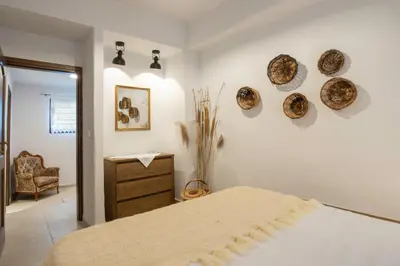 a bedroom with a bed with plates on the wall at Mareò Traditional Retreat in Archangelos