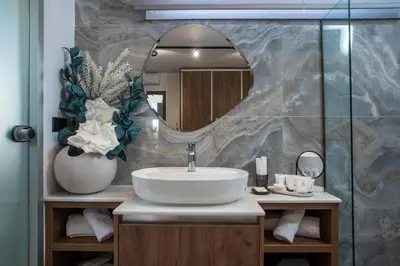 a bathroom with a sink and a mirror at Olea Luxury Apartment in Afantou