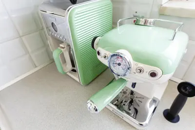 a green and white hair dryer sitting in a room at abk apartment in Afantou