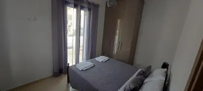 a bedroom with a bed with two towels on it at Dionysia apartments in Livadia
