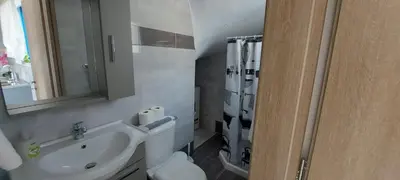 a bathroom with a toilet and a sink and a shower at Dionysia apartments in Livadia