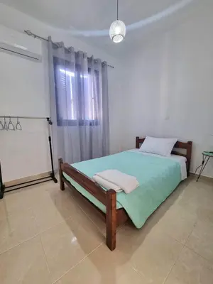 a bedroom with a bed in a room with a window at Dionysia apartments in Livadia