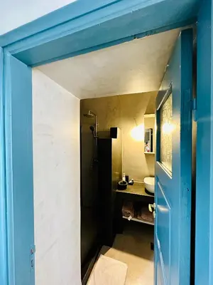 a bathroom with a blue door and a sink at Evangelia in Symi