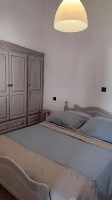 a bedroom with a large bed and a light fixture at Evangelia in Symi