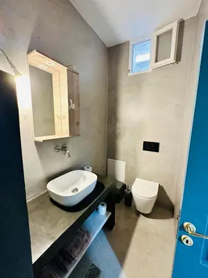 a bathroom with a sink and a toilet at Evangelia in Symi