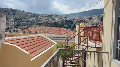 a view of a city from the balcony of a house at Evangelia in Symi