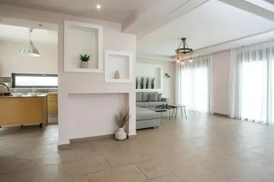 a living room with a couch and a fireplace at Villa Aurora in Faliraki