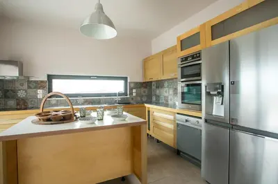 a kitchen with a stainless steel refrigerator and a counter at Villa Aurora in Faliraki