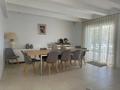 a dining room with a wooden table and chairs at Solis Lindos Villa in Líndos