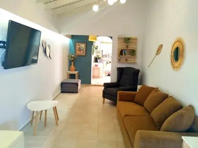 a living room with a couch and a chair at Beach House Cavo Kiotari in Gennadi