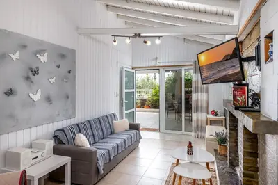 a living room with a couch and a tv at Beach House Cavo Kiotari in Gennadi