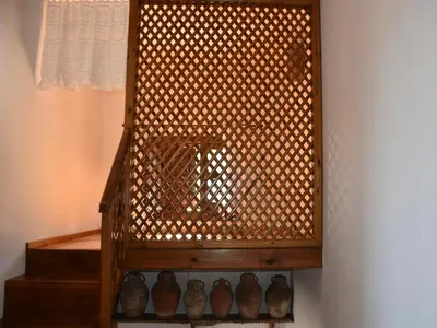a wooden bird cage with vases on a shelf at MOM'S RETREAT in Siána