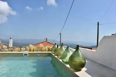 a row of vases sitting next to a swimming pool at MOM'S RETREAT in Siána