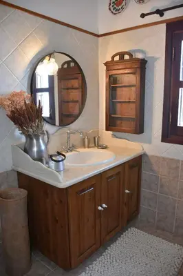 a bathroom with a sink and a mirror at MOM'S RETREAT in Siána