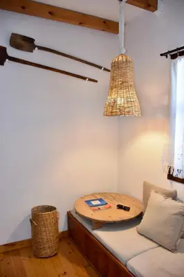 a room with a bed with a table and a chandelier at MOM'S RETREAT in Siána