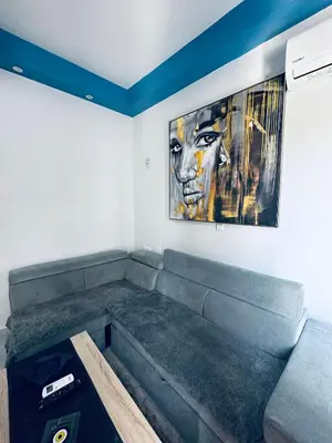 a couch in a room with a painting on the wall at JZ Boutique 2 in Rhodes Town