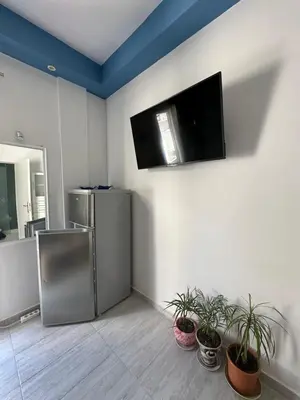 a living room with a refrigerator and potted plants at JZ Boutique 2 in Rhodes Town
