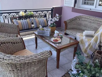 a living room with wicker chairs and a coffee table at Aithrea's HOMES in Pastida Rhodes in Pastida