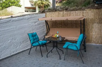 two blue chairs and a table on a patio at Irinis studio in Rhodes Town