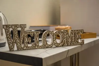 a metal sign that says wine on a counter at Irinis studio in Rhodes Town