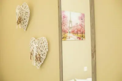 two hearts hanging on a wall next to a mirror at Irinis studio in Rhodes Town