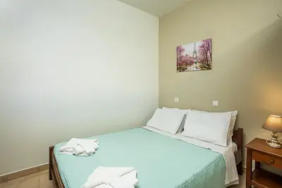 a bedroom with a bed with two towels on it at Irinis studio in Rhodes Town
