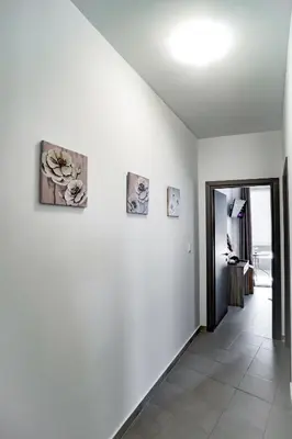 a hallway with three pictures on the wall at Maquestas Modern Apartments in Archangelos