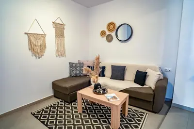 a living room with a couch and a table at Maquestas Modern Apartments in Archangelos