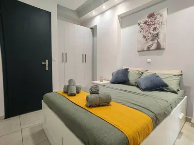 a bedroom with a large bed with two stuffed animals on it at The Cozy Nest in Rhodes town in Rhodes Town