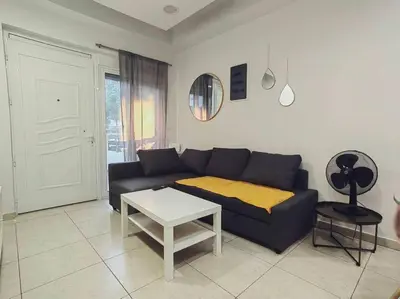 a living room with a couch and a table at The Cozy Nest in Rhodes town in Rhodes Town