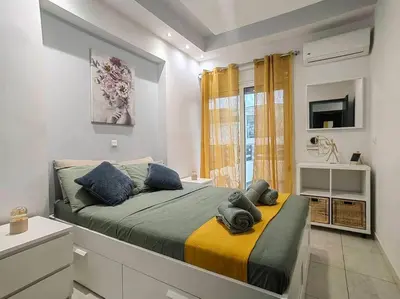 a bedroom with a bed and a tv and a window at The Cozy Nest in Rhodes town in Rhodes Town