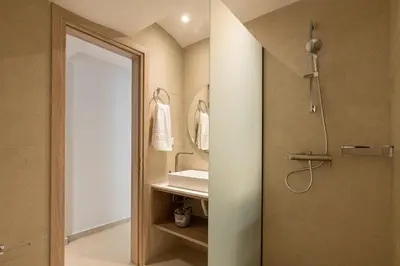 a bathroom with a shower and a sink at Aqua Villa Faliraki in Faliraki