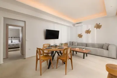 a living room with a table and a couch at Aqua Villa Faliraki in Faliraki