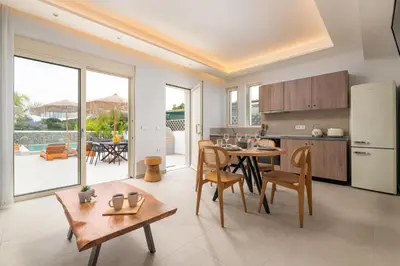 a kitchen and dining room with a table and chairs at Aqua Villa Faliraki in Faliraki