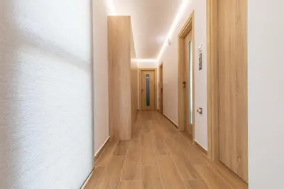 an empty hallway with white walls and wood floors at Armonia Luxury Villa in Triánta