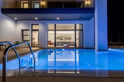 a swimming pool in front of a house at Armonia Luxury Villa in Triánta