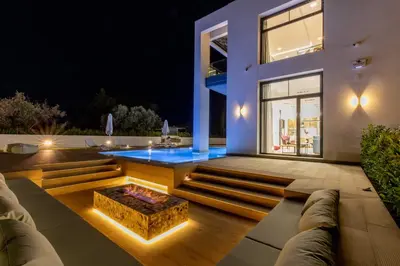a house with a fire pit in the middle of a patio at Armonia Luxury Villa in Triánta
