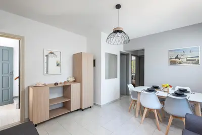 a kitchen and dining room with a table and chairs at FOURLANOU HOUSE in Halki