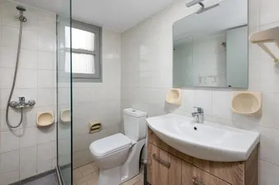 a bathroom with a toilet and a sink and a shower at FOURLANOU HOUSE in Halki
