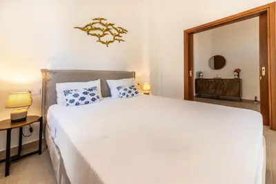a bedroom with a white bed and a mirror at Kira's House Rhodes Town in Rhodes Town